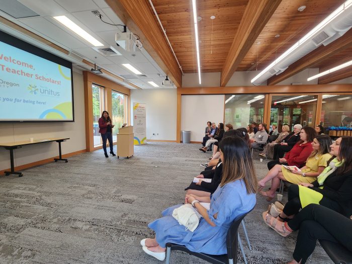 audience listens to keynote speaker at bilingual scholars event