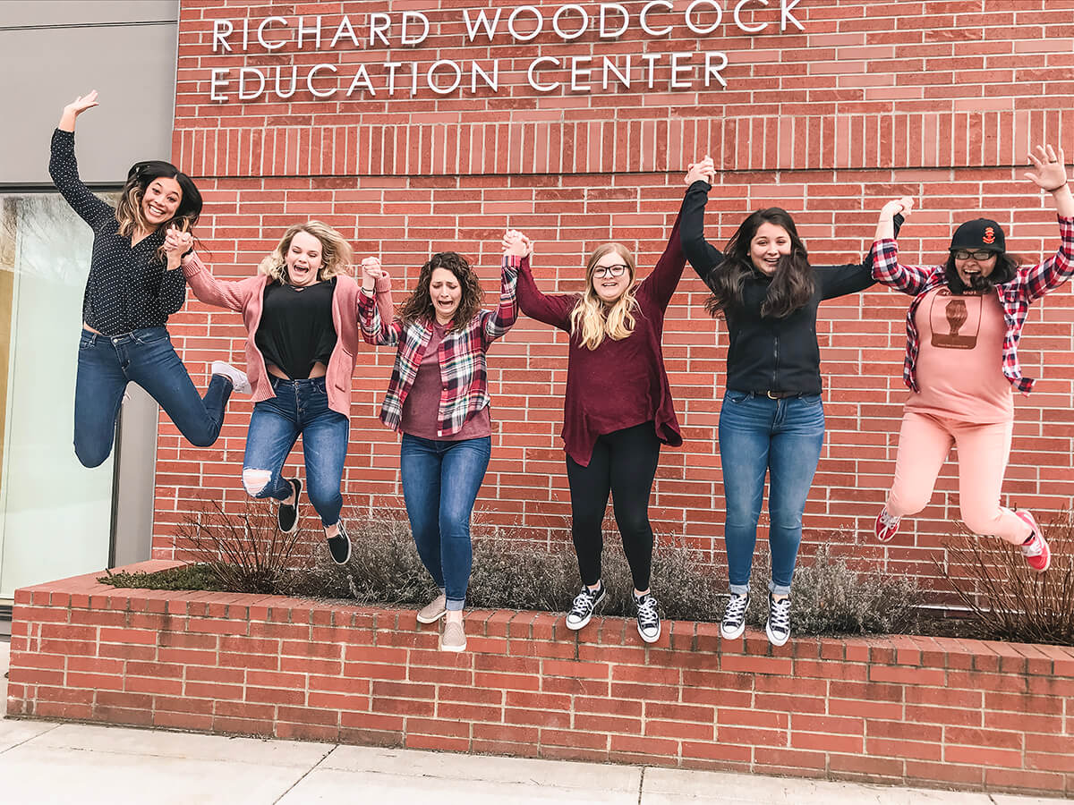 a group of people jumping in the air